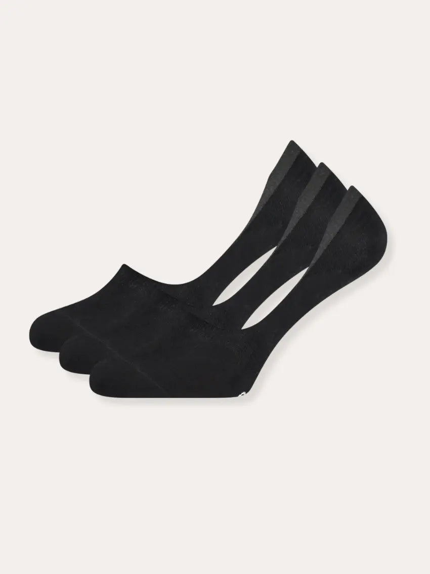 Three pairs of black socks on a white background